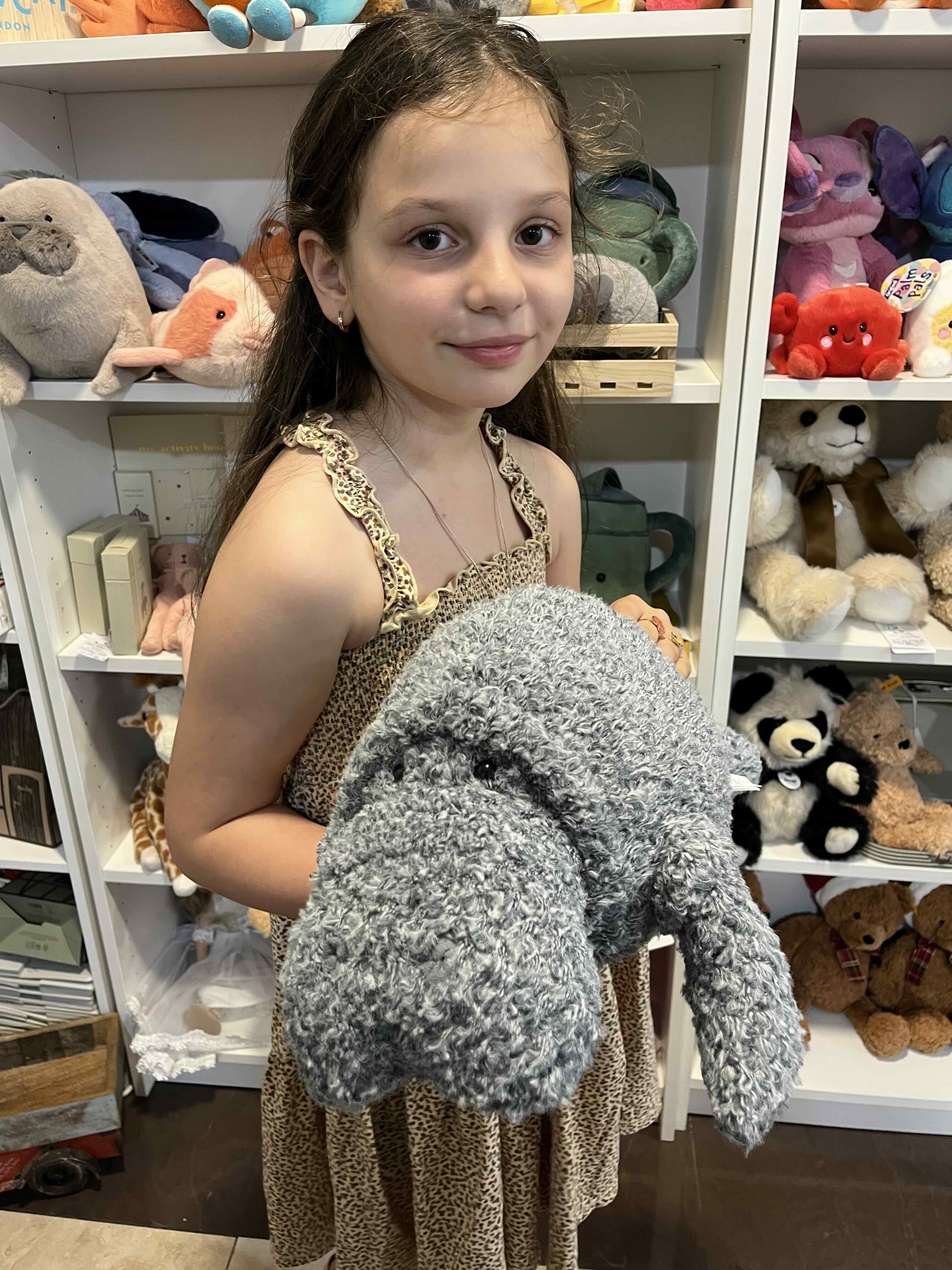 A child exploring a large plush toy inside My Snowdrop