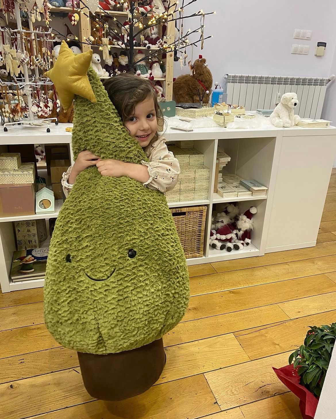 Our daughter back in 2021 with a Jellycat Christmas tree