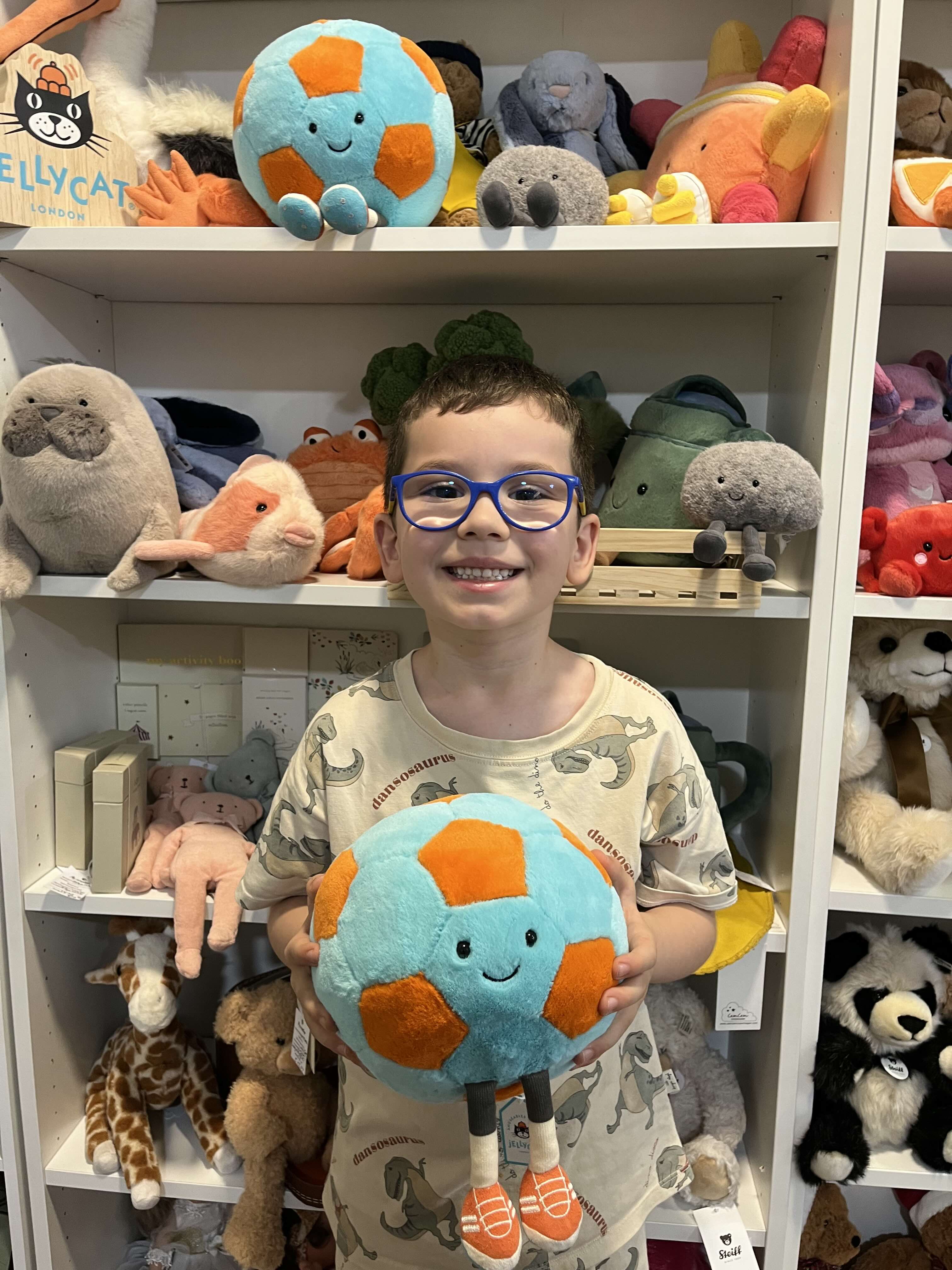 Hristo with newly arrived toys inside the My Snowdrop family store